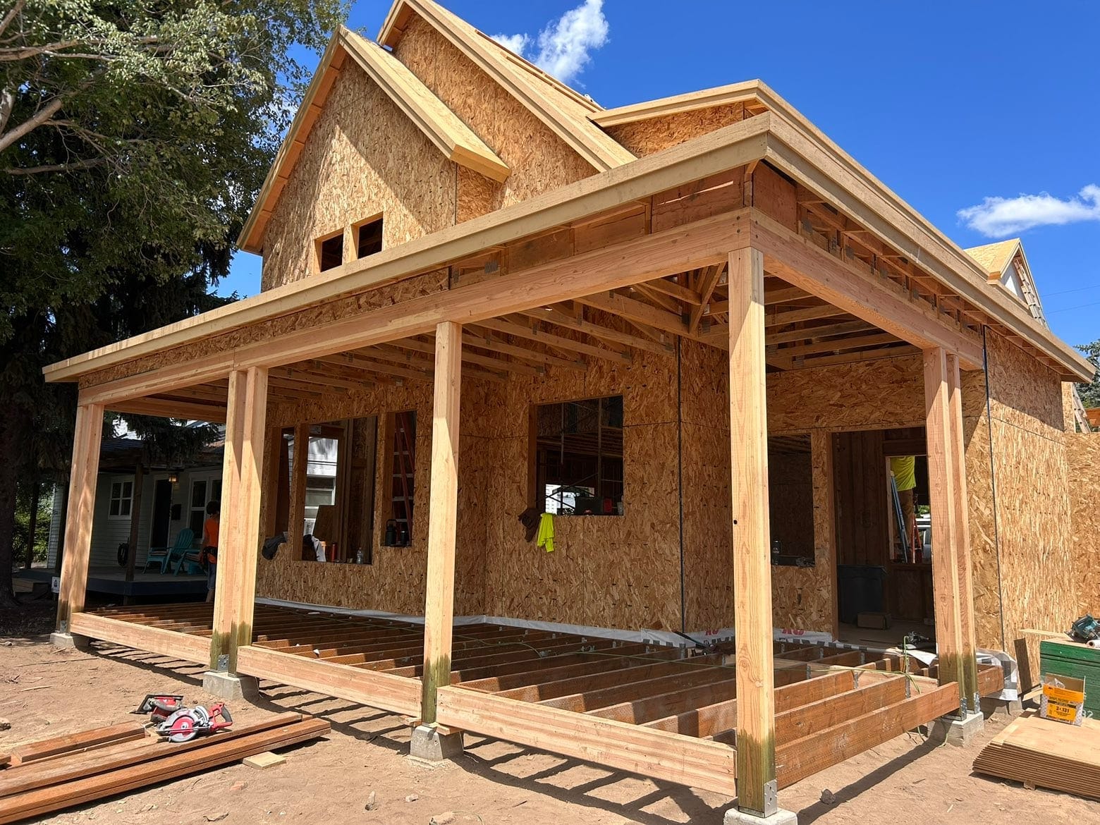 Farmhouse-style home under framing with a deep covered front porch in downtown Bend